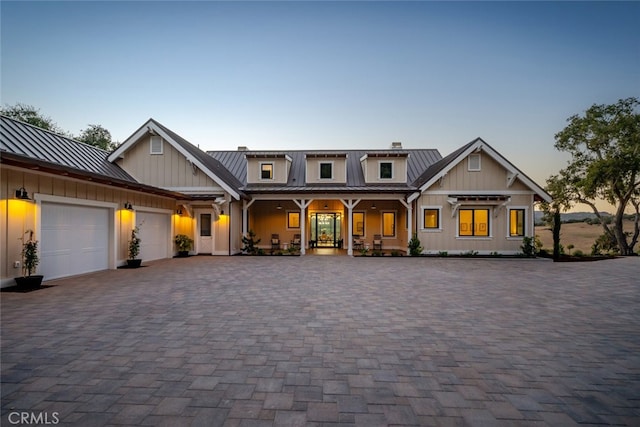 view of front of house featuring a porch and a garage