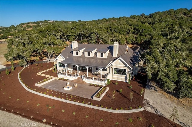 birds eye view of property with a forest view