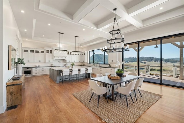 dining space featuring recessed lighting, beamed ceiling, coffered ceiling, and light wood finished floors