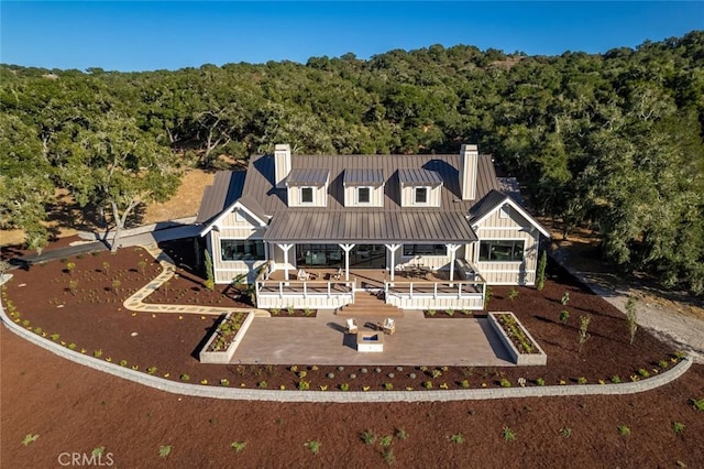 birds eye view of property with a forest view