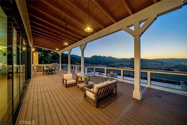 deck at dusk with a mountain view