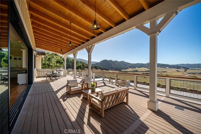 wooden deck with a rural view and a mountain view