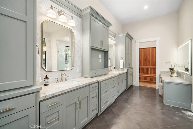 full bath with double vanity, tasteful backsplash, and a sink