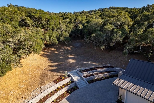 birds eye view of property featuring a wooded view