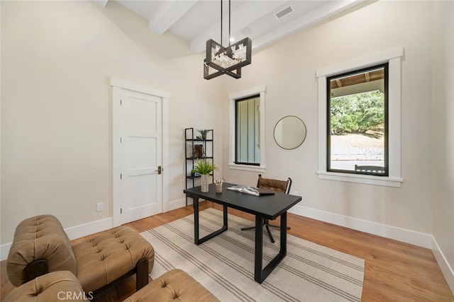 office area with light wood-type flooring, beam ceiling, and a chandelier