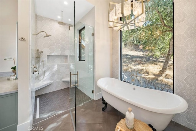 full bath featuring a freestanding tub, a shower stall, and tile patterned flooring