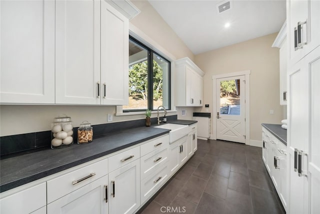 kitchen featuring sink and white cabinetry