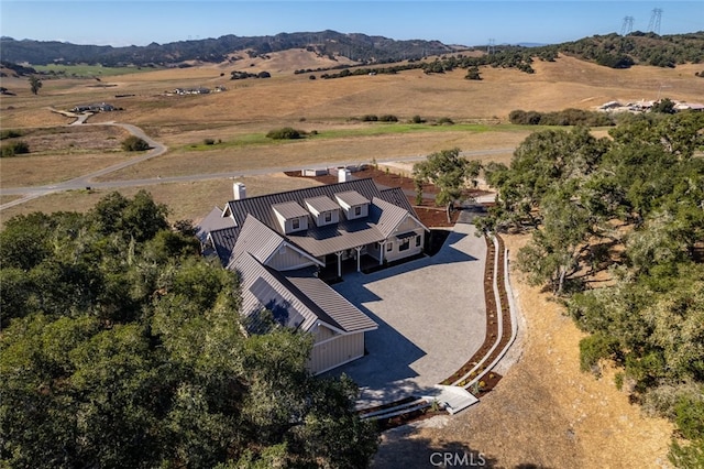 drone / aerial view featuring a mountain view and a rural view