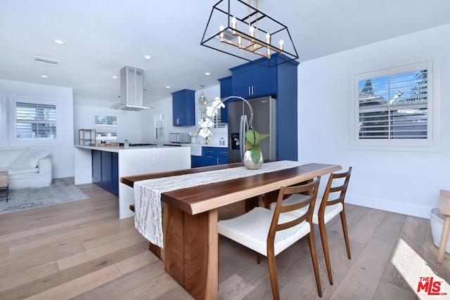 dining space featuring plenty of natural light and light wood-type flooring