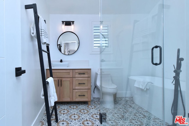 bathroom featuring vanity, toilet, and a shower with shower door