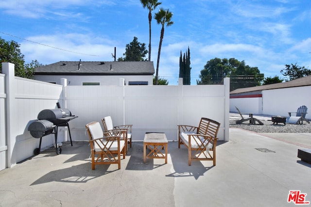 view of patio featuring a fire pit and grilling area