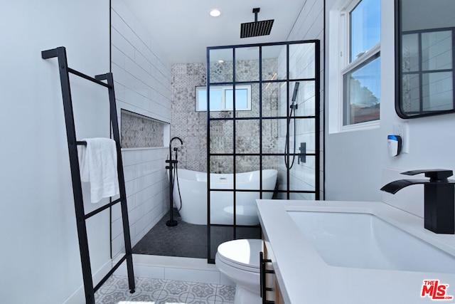 full bathroom with tile patterned floors, separate shower and tub, vanity, and toilet