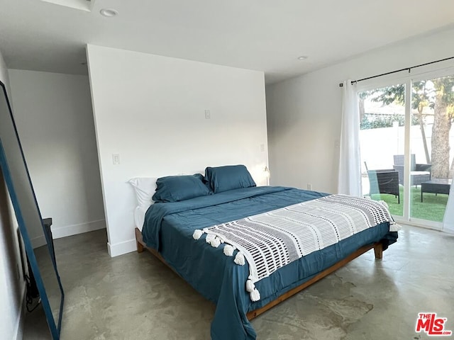 bedroom featuring concrete floors