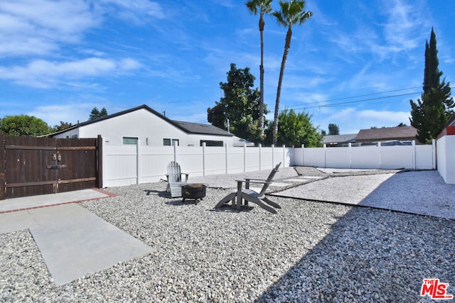 view of yard featuring a patio and an outdoor fire pit