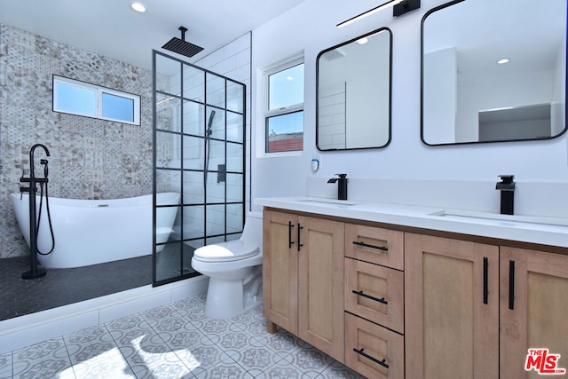 full bathroom with tile patterned floors, toilet, vanity, and shower with separate bathtub