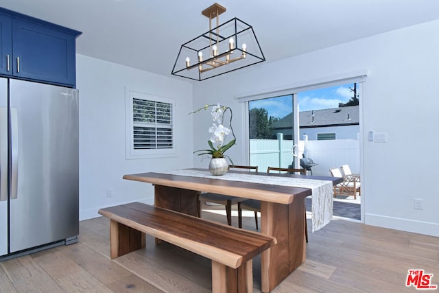 dining area with a notable chandelier and light wood-type flooring