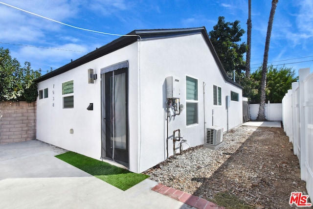 view of side of property featuring ac unit