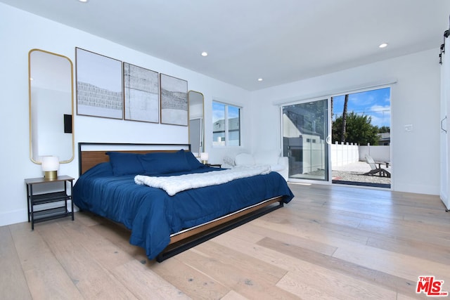 bedroom featuring access to outside and light hardwood / wood-style floors