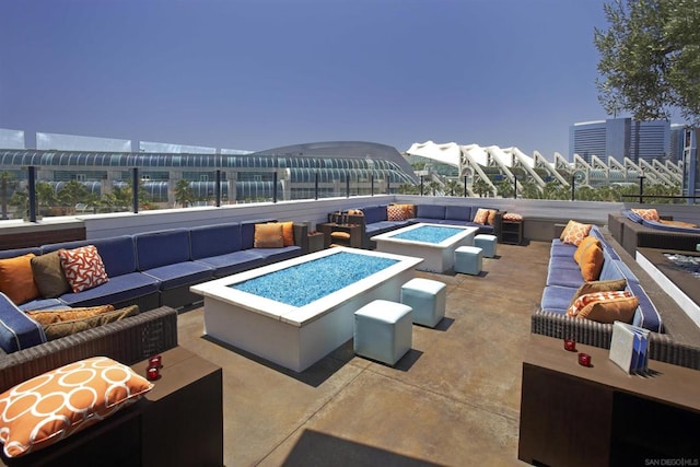 view of swimming pool with a patio and an outdoor living space with a fire pit