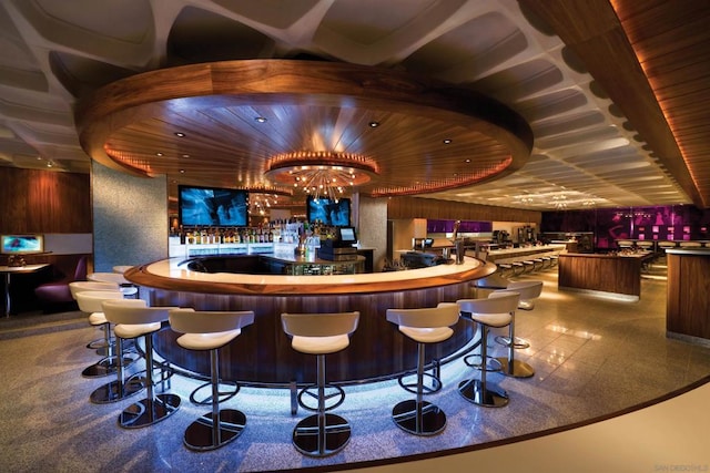 bar featuring wood ceiling and a chandelier