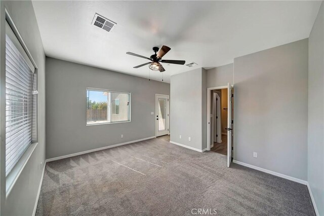 unfurnished bedroom featuring light carpet and ceiling fan