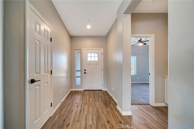 foyer with ceiling fan and light wood-type flooring