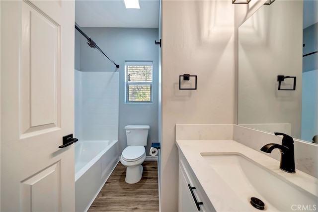 full bathroom with vanity, bathing tub / shower combination, toilet, and hardwood / wood-style flooring