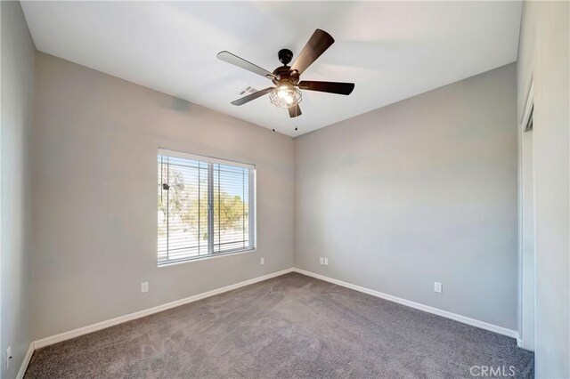 spare room with carpet floors and ceiling fan