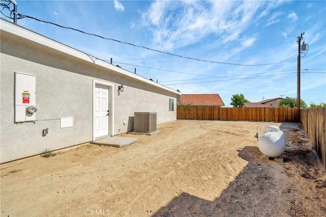 view of yard with central AC unit and a patio area