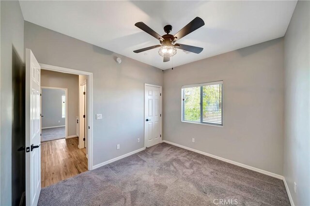 unfurnished bedroom with ceiling fan and carpet flooring