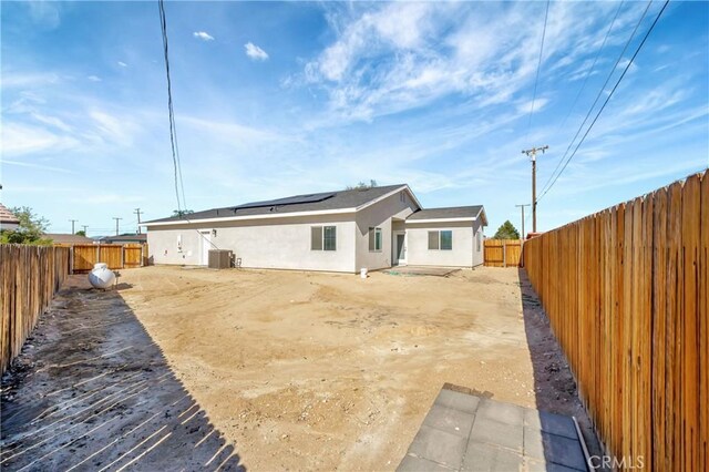 rear view of property featuring a patio and cooling unit