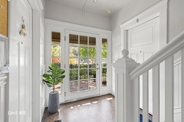 doorway featuring a healthy amount of sunlight and speckled floor