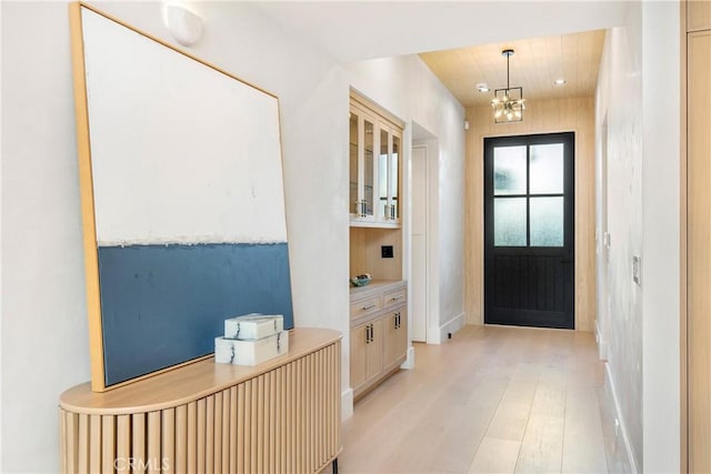 entryway featuring a chandelier and light hardwood / wood-style floors