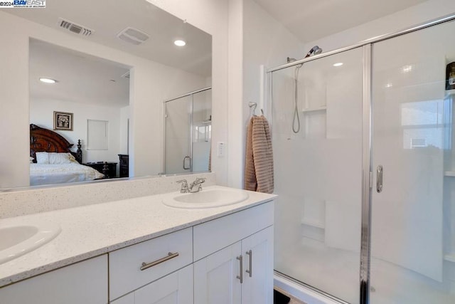 bathroom with vanity and a shower with shower door