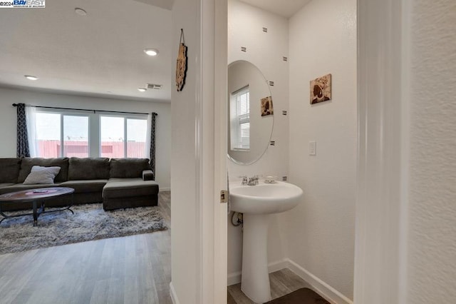 bathroom with hardwood / wood-style floors and sink