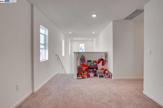 recreation room featuring light colored carpet