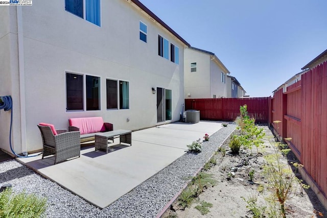 back of house with cooling unit, outdoor lounge area, and a patio area