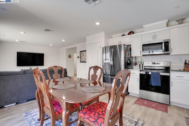 dining space featuring light wood-type flooring