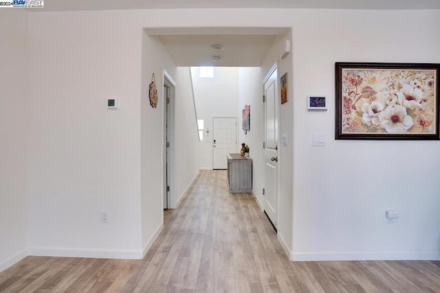 hall with light hardwood / wood-style floors