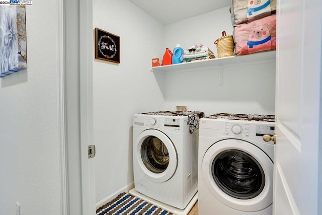 clothes washing area with separate washer and dryer