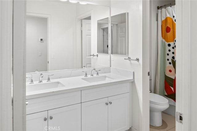 bathroom with a shower with shower curtain, tile patterned floors, vanity, and toilet