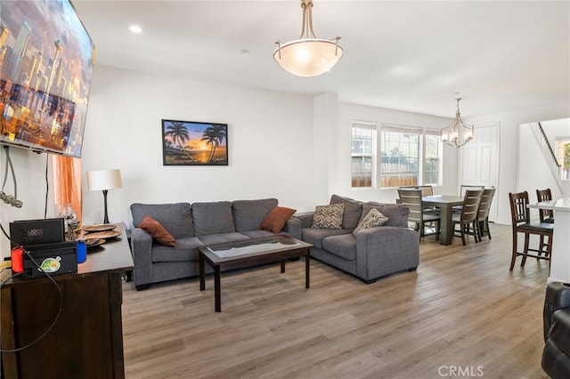 living room with wood-type flooring and a notable chandelier