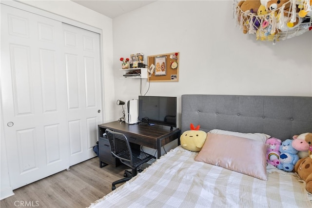 bedroom with wood-type flooring and a closet