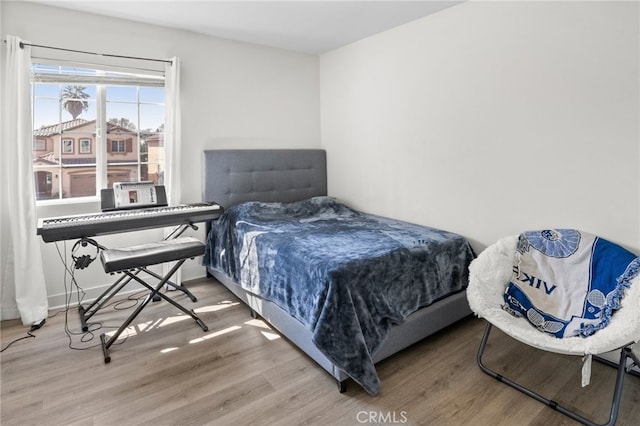 bedroom with hardwood / wood-style flooring