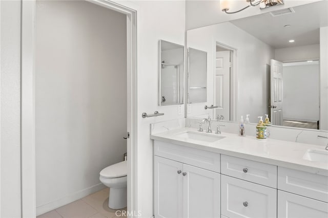 bathroom featuring tile patterned flooring, a shower, vanity, and toilet