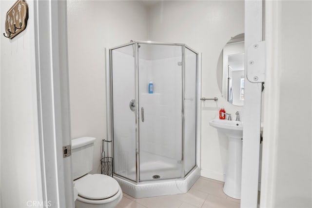 bathroom with tile patterned floors, an enclosed shower, and toilet