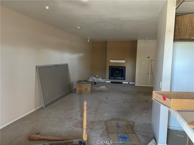 unfurnished living room featuring dark carpet