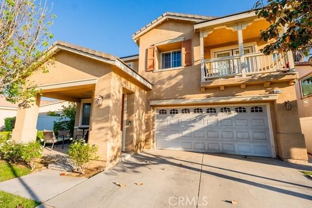 view of front of home featuring a balcony and a garage