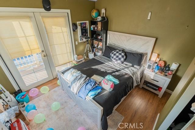 bedroom featuring wood-type flooring and french doors