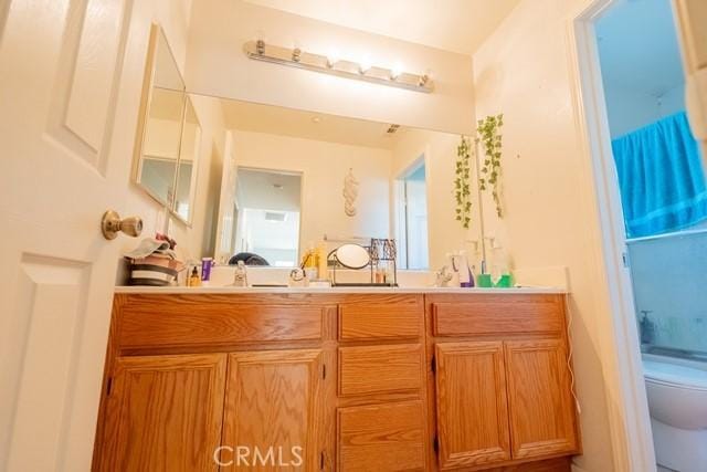 bathroom featuring vanity and toilet